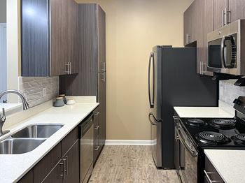 A kitchen with stainless steel appliances and wooden cabinets